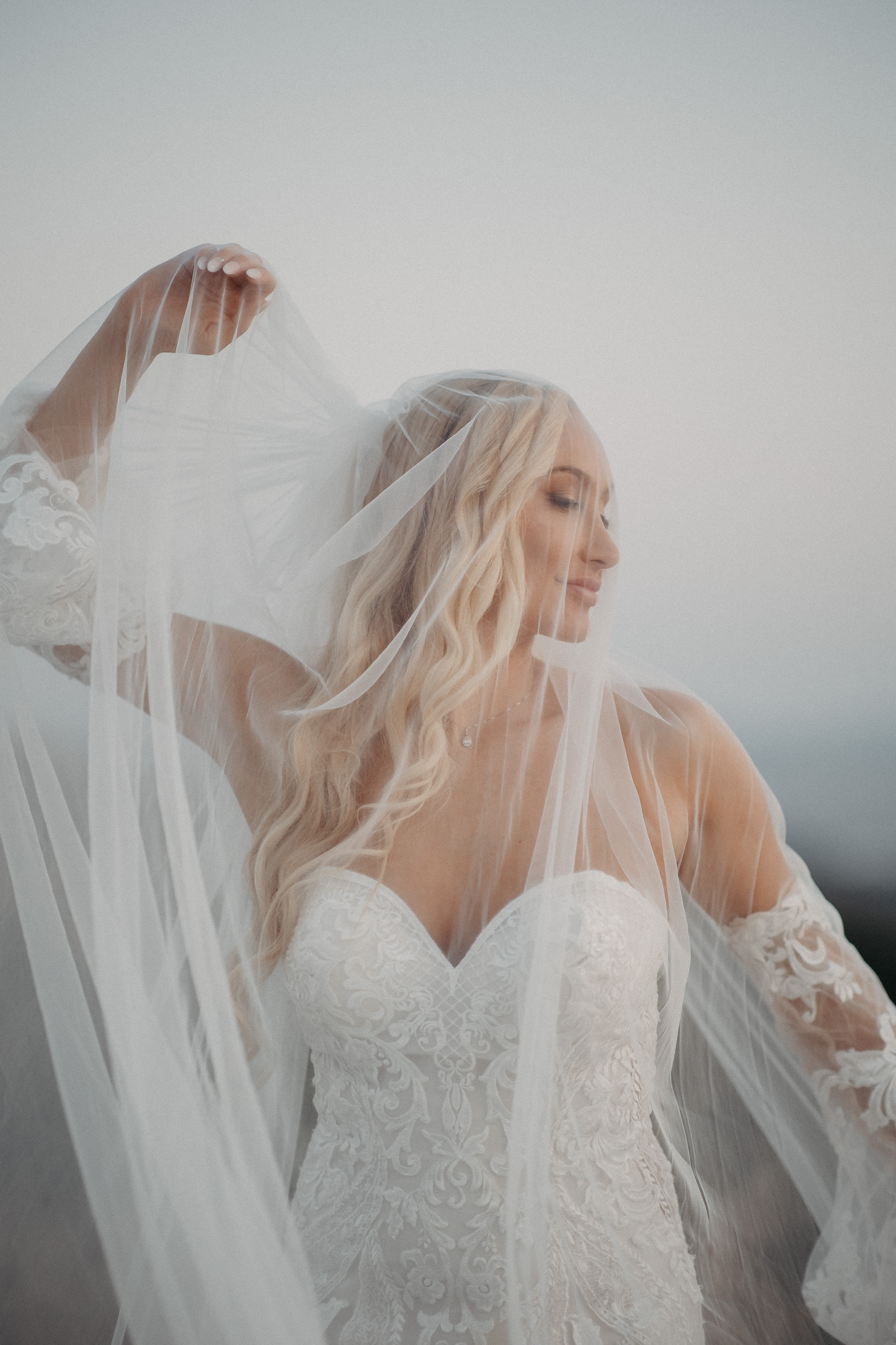 Elegant bride with flowing veil bridal portrait